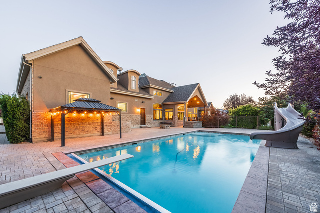 694 West Cephus Road Draper, UT 84020 - Photo 142 of 148 Expansive backyard featuring a large swimming pool with a diving board and waterslide