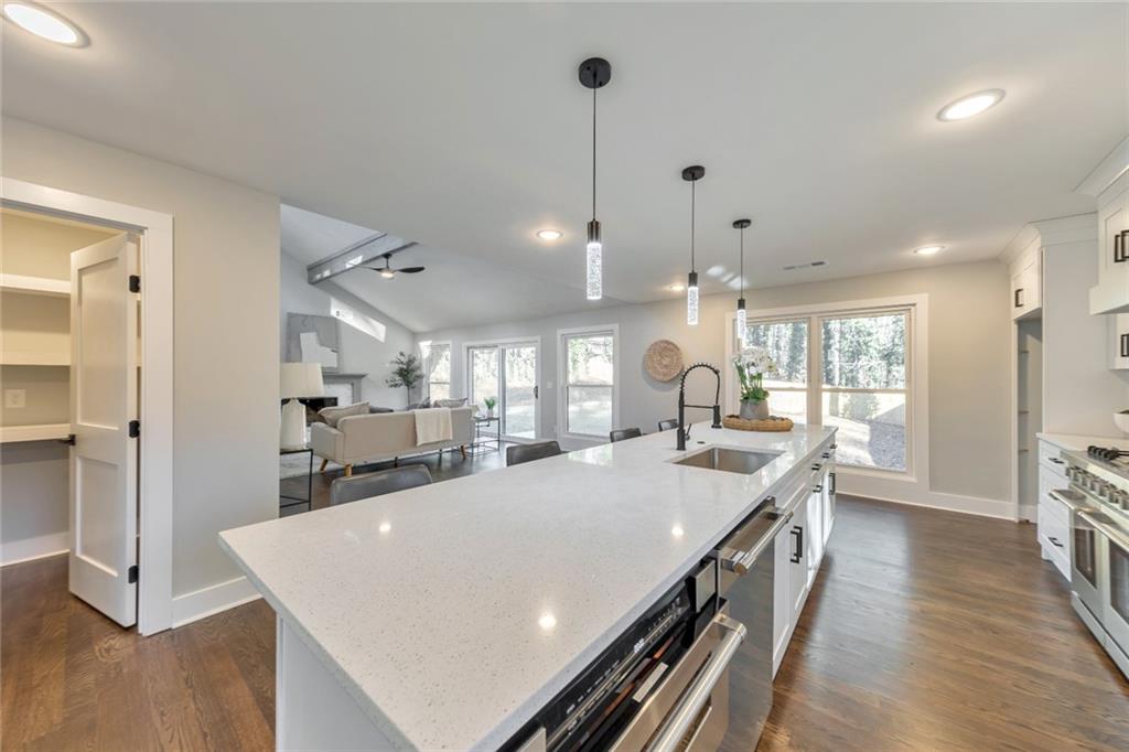 2066 Old Forge Way Marietta, GA 30068 - Photo 16 of 54 a large kitchen with kitchen island a stove a sink a refrigerator and wooden floor