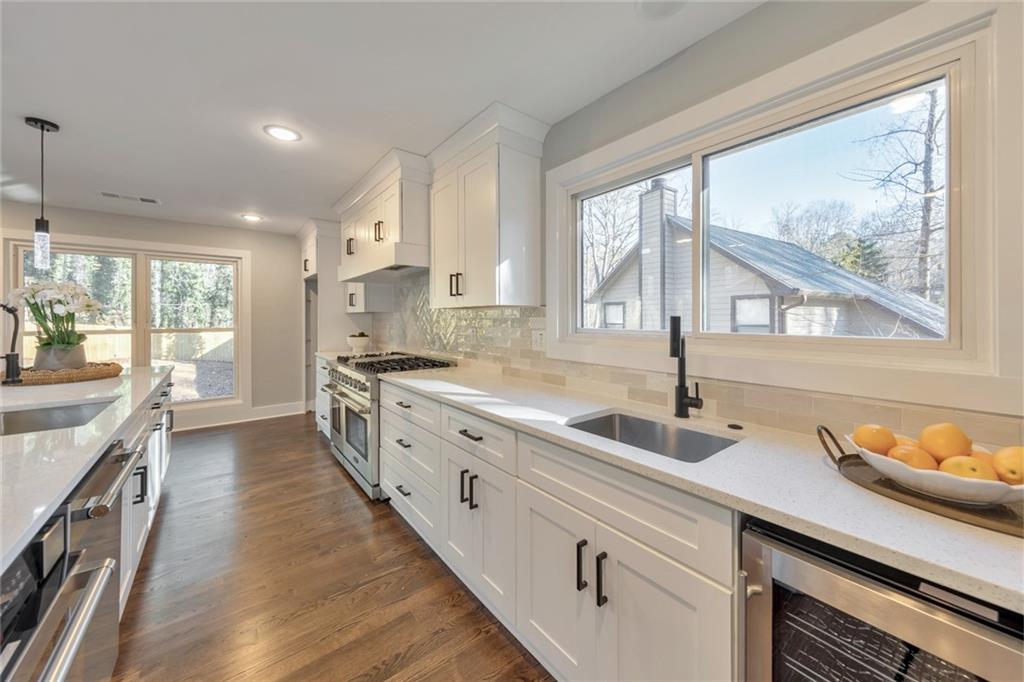 2066 Old Forge Way Marietta, GA 30068 - Photo 17 of 54 a large kitchen with granite countertop a large window and a sink