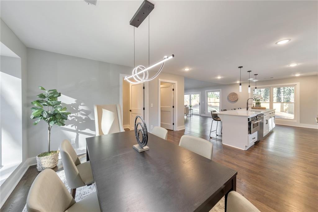 2066 Old Forge Way Marietta, GA 30068 - Photo 18 of 54 a view of a dining room and livingroom with furniture wooden floor a chandelier