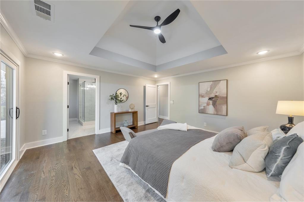 2066 Old Forge Way Marietta, GA 30068 - Photo 23 of 54 a spacious bedroom with a large bed a chandelier and closet