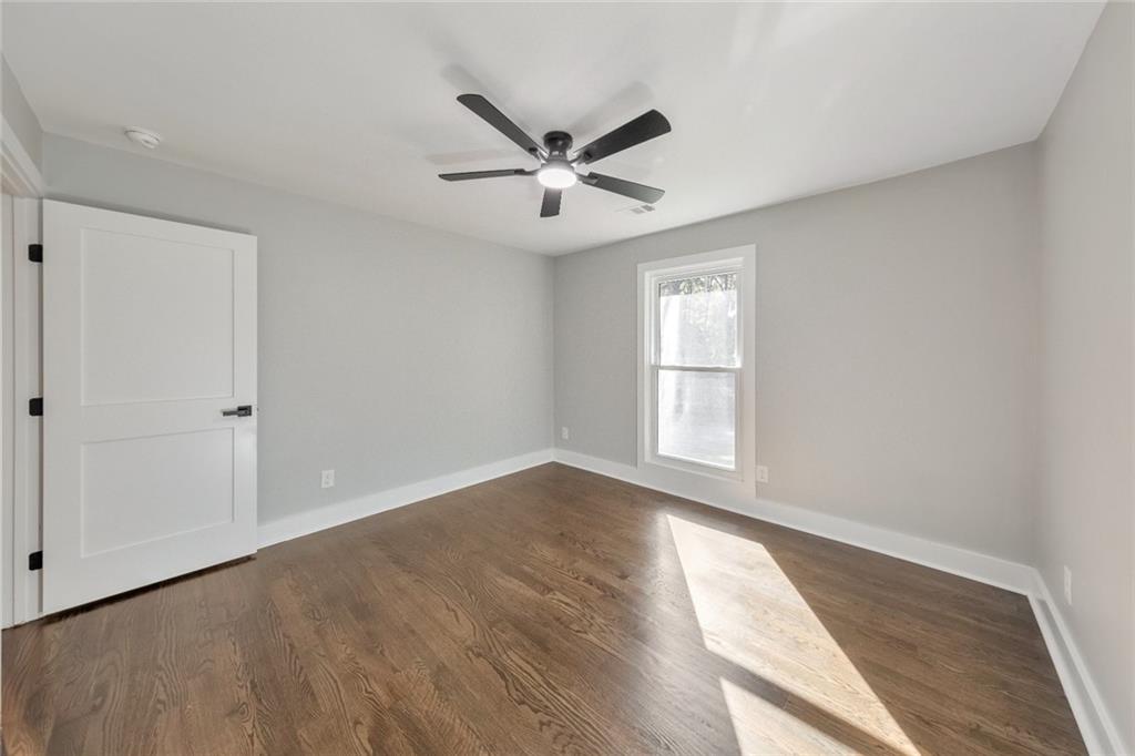 2066 Old Forge Way Marietta, GA 30068 - Photo 26 of 54 a view of empty room with wooden floor and fan