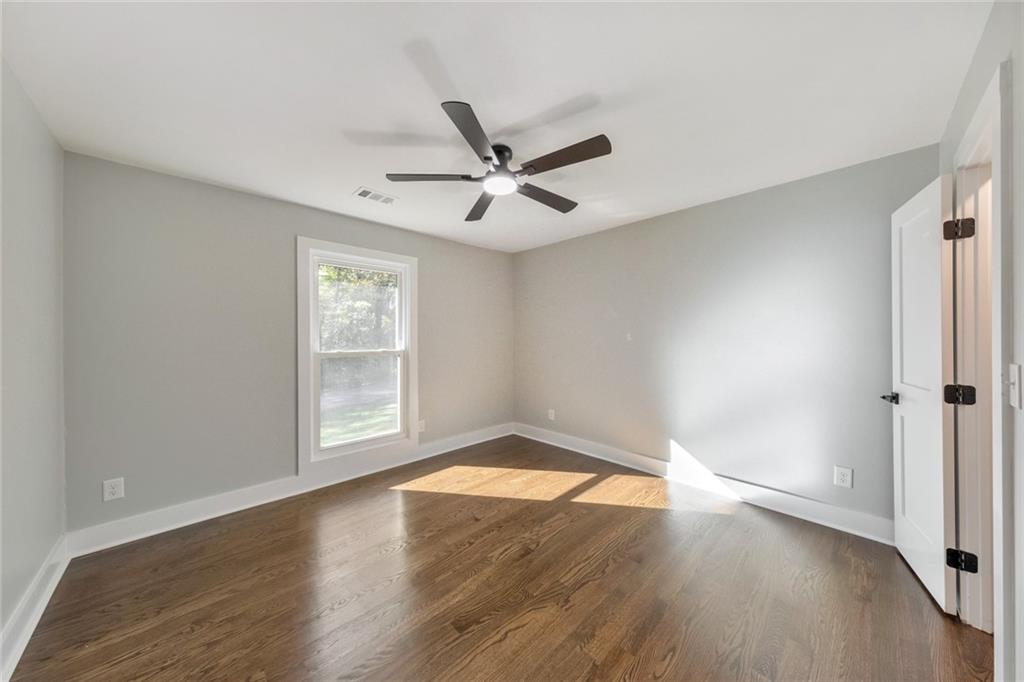 2066 Old Forge Way Marietta, GA 30068 - Photo 27 of 54 an empty room with wooden floor and windows