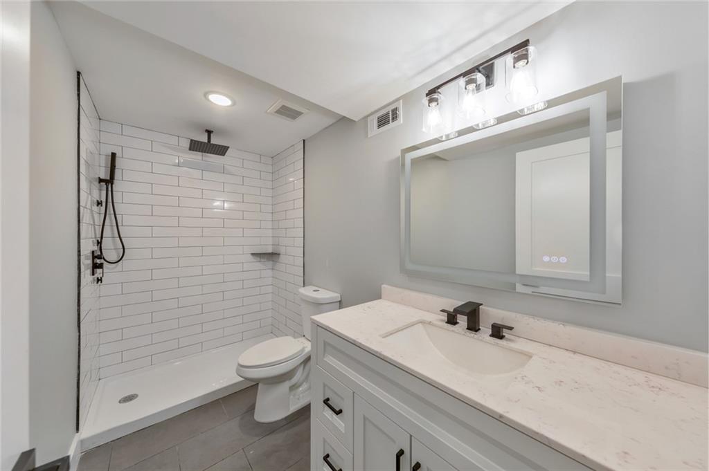 2066 Old Forge Way Marietta, GA 30068 - Photo 36 of 54 a bathroom with a granite countertop sink a toilet and shower
