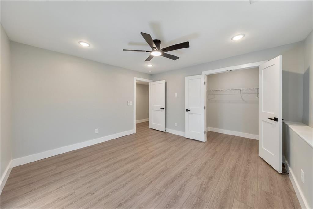 2066 Old Forge Way Marietta, GA 30068 - Photo 37 of 54 an empty room with wooden floor and a ceiling fan