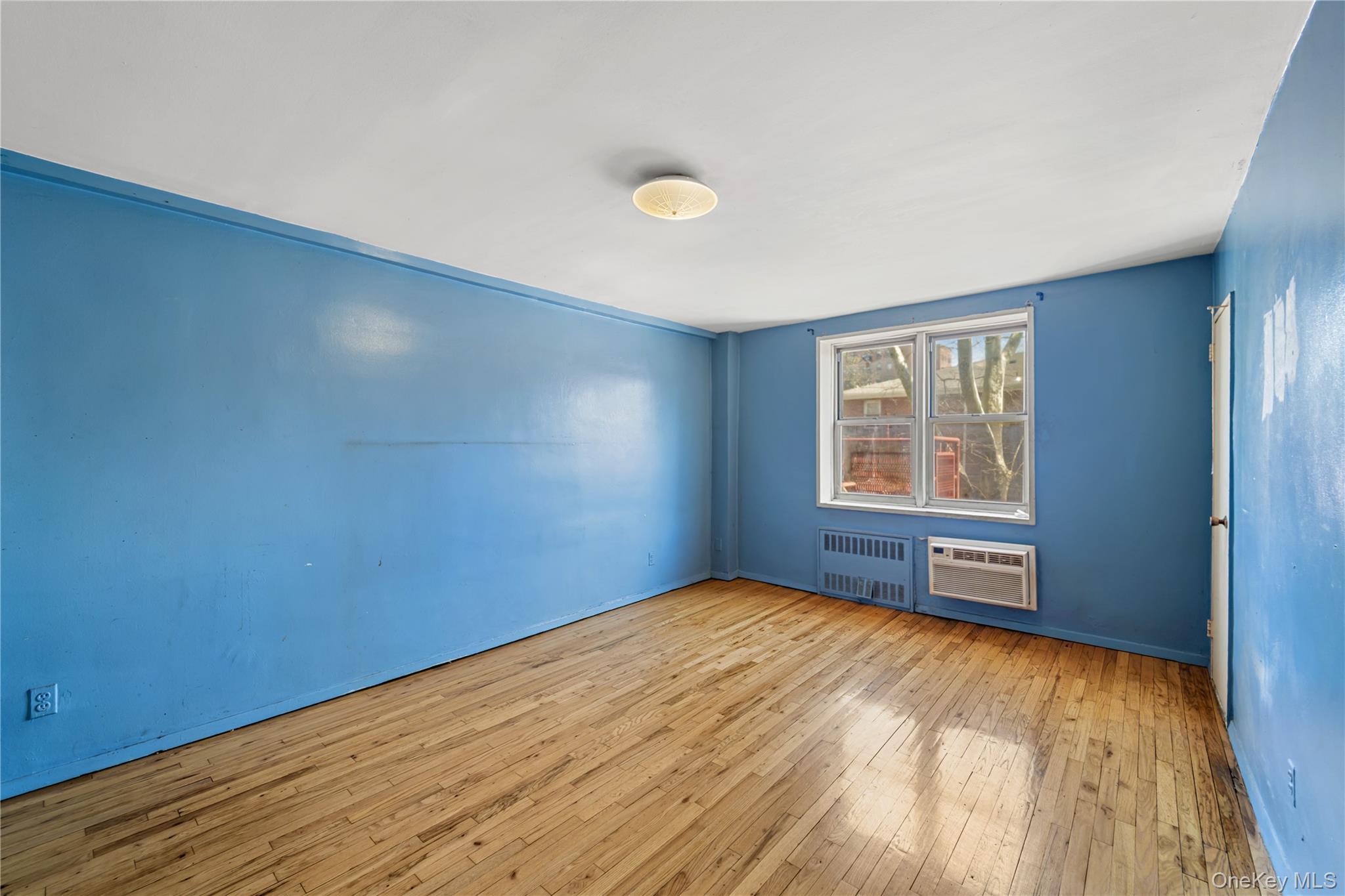 600 Locust Street, Unit 3G Mount Vernon, NY 10552 - Photo 14 of 25 wooden floor in an empty room with a window