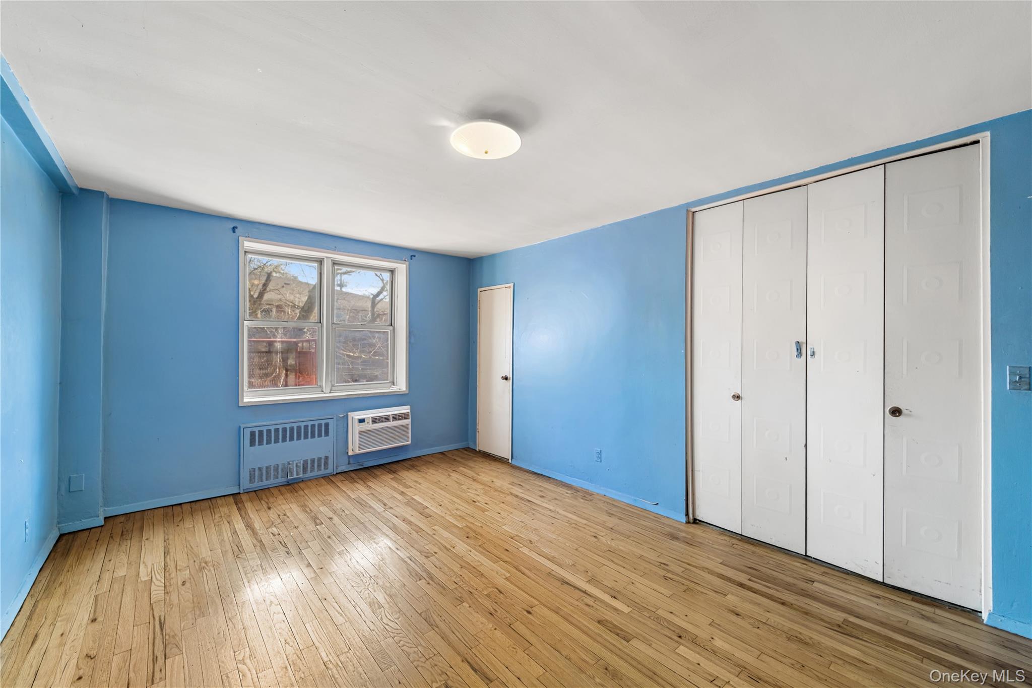 600 Locust Street, Unit 3G Mount Vernon, NY 10552 - Photo 15 of 25 a view of an empty room with a window and wooden floor