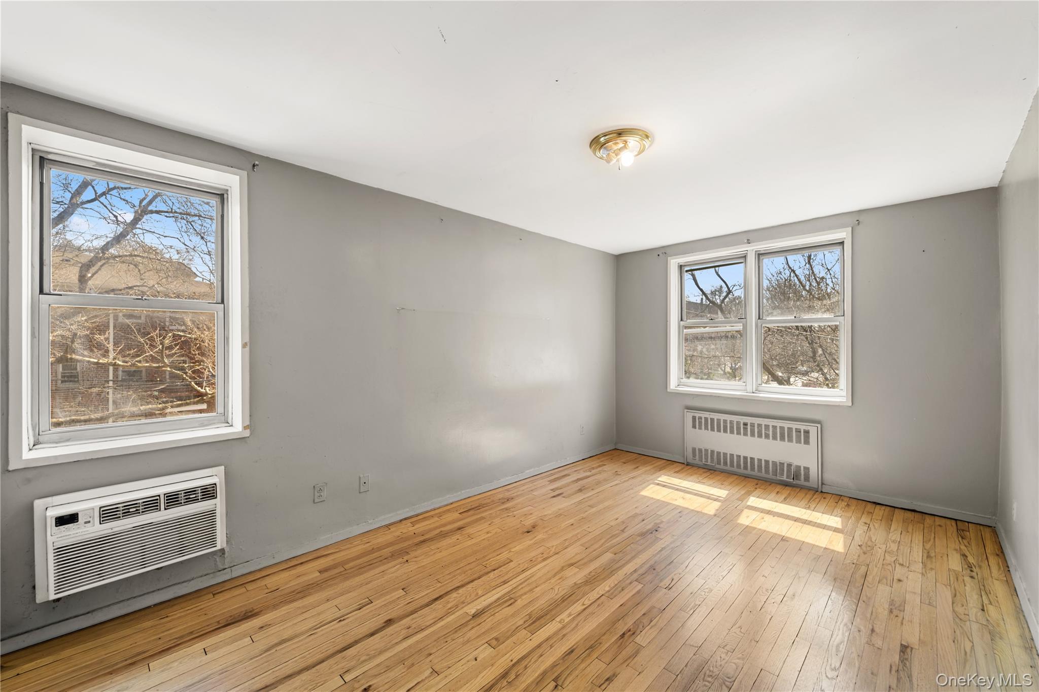 600 Locust Street, Unit 3G Mount Vernon, NY 10552 - Photo 18 of 25 a view of an empty room with a window and wooden floor
