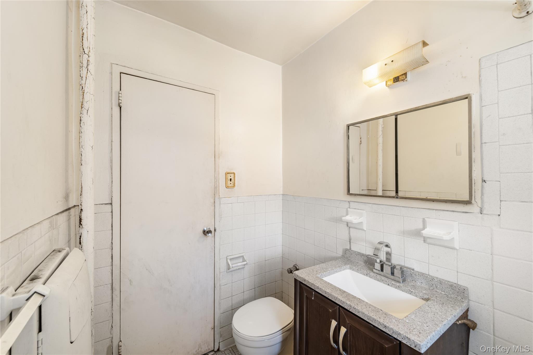 600 Locust Street, Unit 3G Mount Vernon, NY 10552 - Photo 20 of 25 a bathroom with a sink vanity mirror and toilet