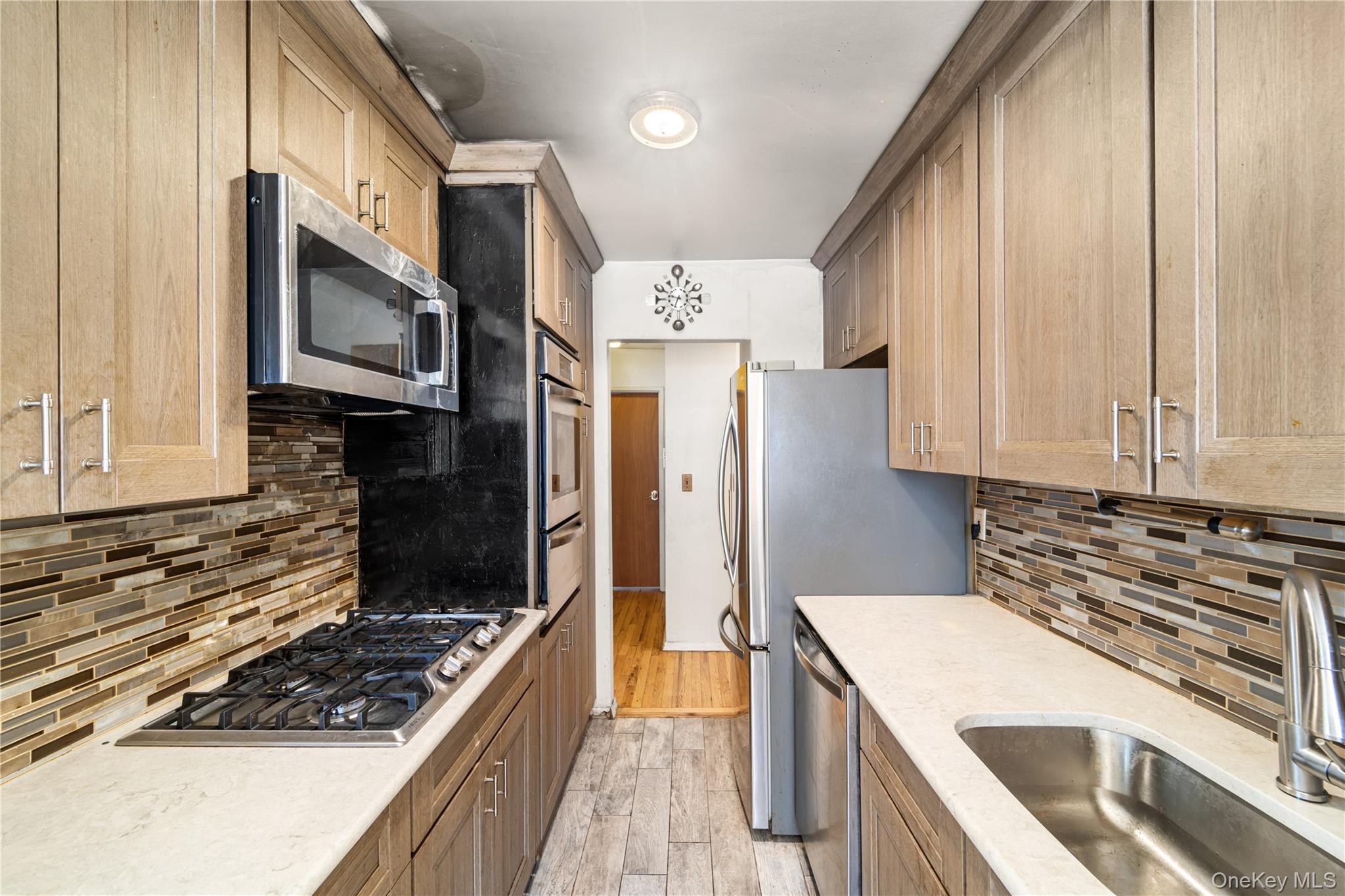 600 Locust Street, Unit 3G Mount Vernon, NY 10552 - Photo 6 of 25 a kitchen with stainless steel appliances granite countertop a stove and a refrigerator