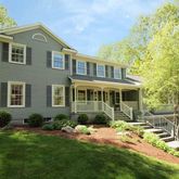 a front view of a house with a yard and porch