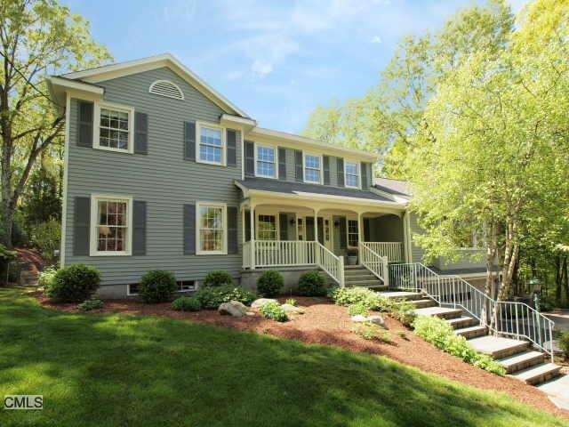 a front view of a house with a yard and porch