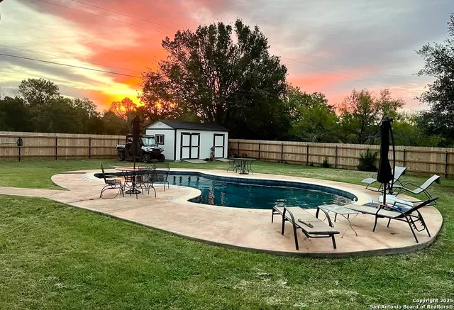 a view of a swimming pool with chairs