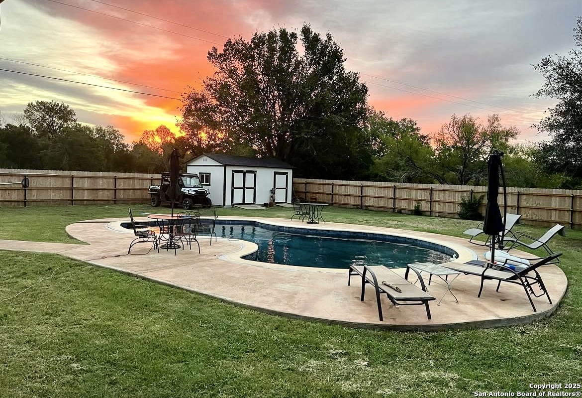 a view of a swimming pool with chairs