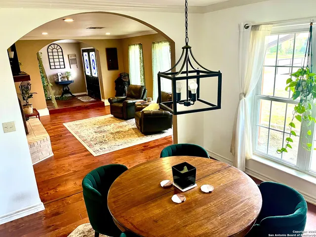 a view of a dining room with furniture window and wooden floor