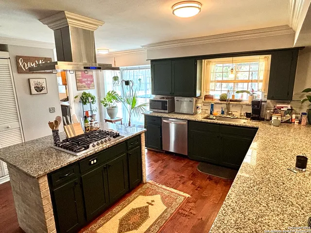 a kitchen with stainless steel appliances granite countertop a sink stove and refrigerator