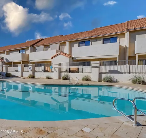 a front view of a house with swimming pool having outdoor seating
