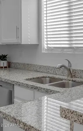 a kitchen with granite countertop a sink and a granite counter tops