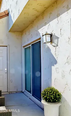 a view of a white house with a potted plant