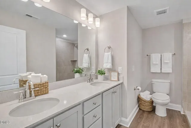 a bathroom with a double vanity sink and a mirror