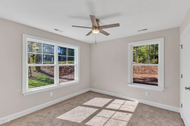 a kitchen with stainless steel appliances granite countertop a sink a stove a refrigerator and white cabinets