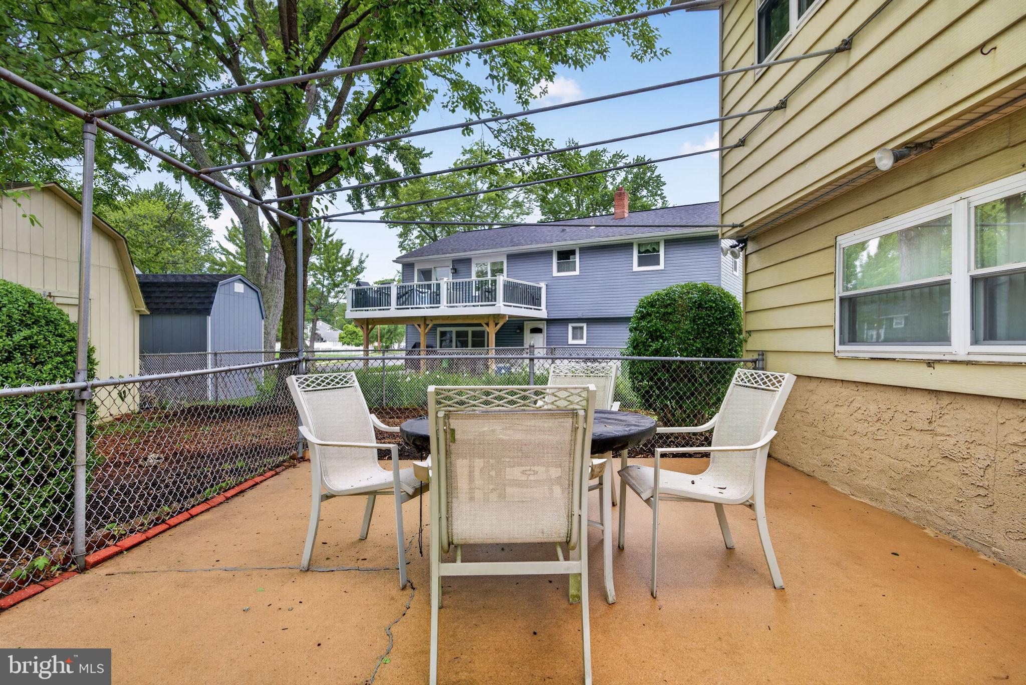 46 Trinity Avenue Marlton, NJ 08053 - Photo 37 of 37 a patio with table and chairs and potted plants