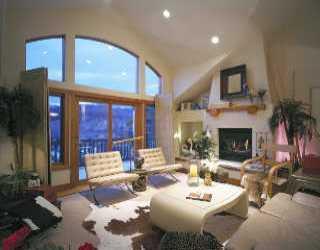 178 Knudson Ranch Road, Unit 22 Edwards, CO 81632 - Photo 1 of 2 a living room with furniture a fireplace and a flat screen tv