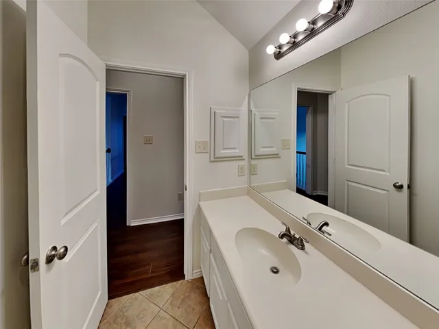 a bathroom with a tub sink and mirror