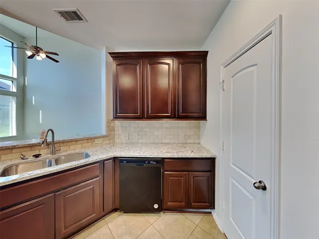 a kitchen with granite countertop a sink and cabinets