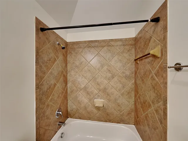 a bathroom with a shower and a tub
