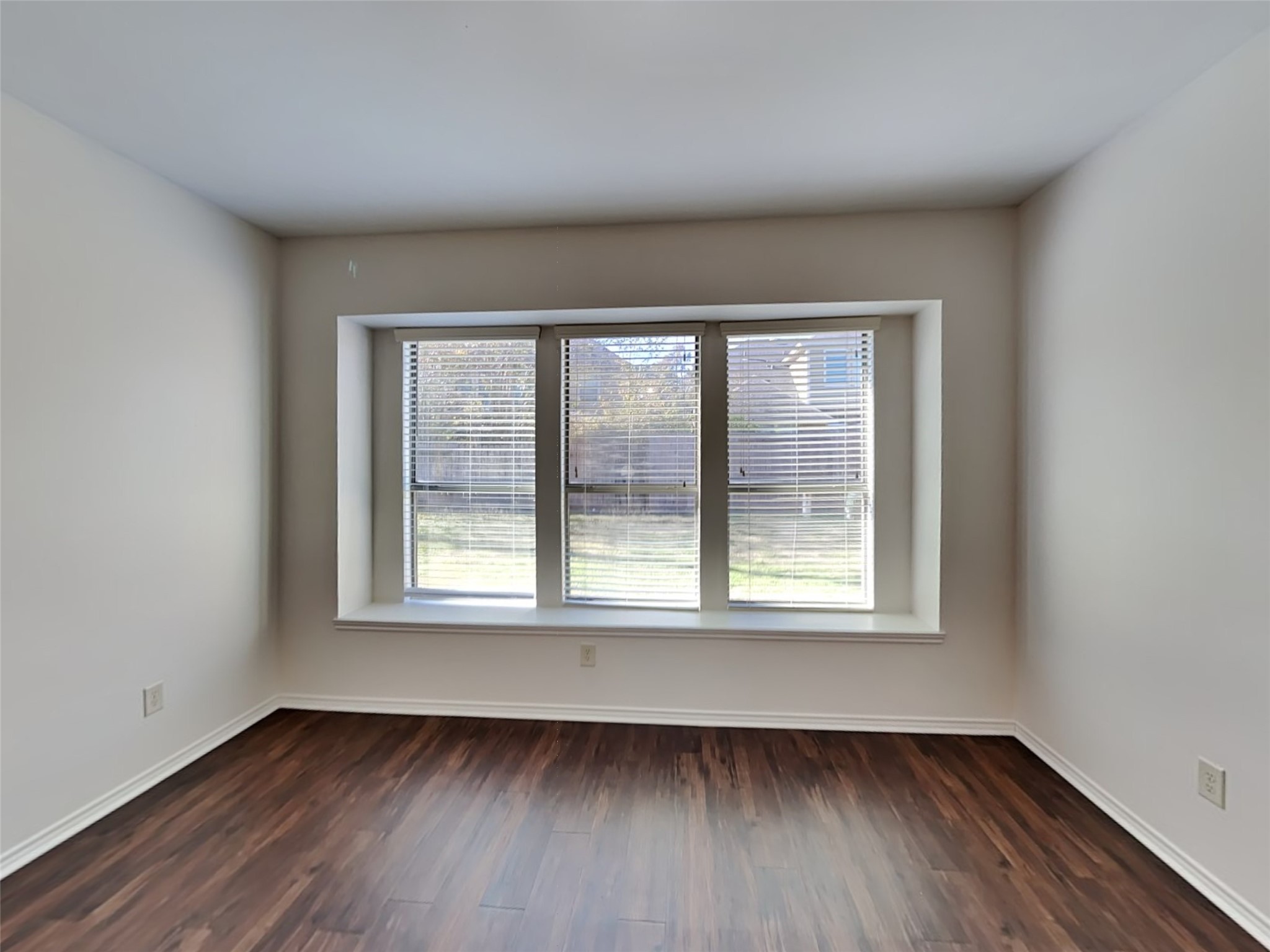 1323 Laura Hills Lane Spring, TX 77386 - Photo 9 of 22 a view of an empty room with wooden floor and a window
