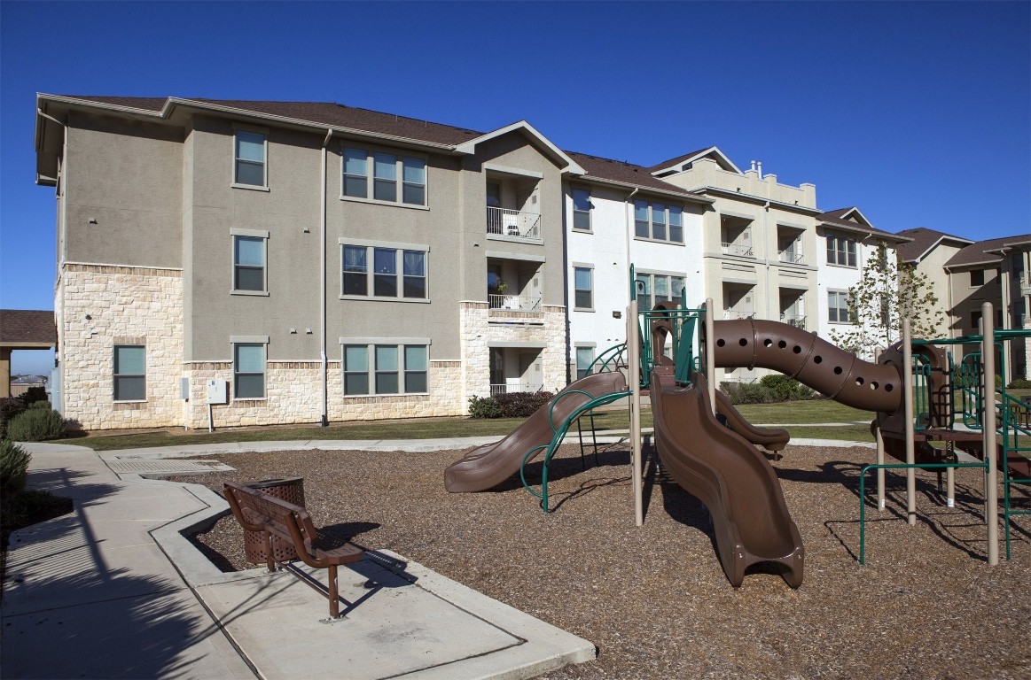 5121 North Foster Road San Antonio, TX 78244 - Photo 4 of 10 a view of a large building with a bench