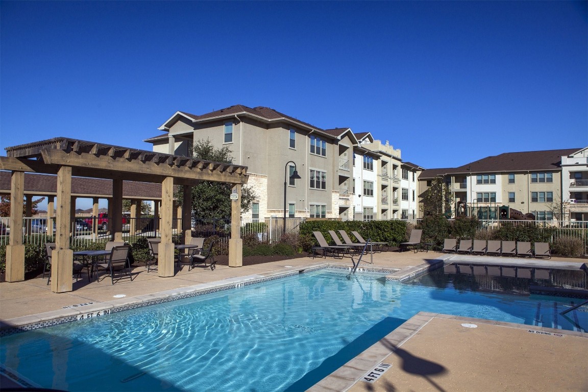 5121 North Foster Road San Antonio, TX 78244 - Photo 6 of 10 a view of a building with a swimming pool and sitting area