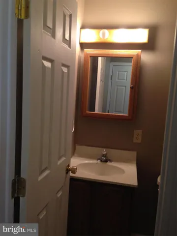 a bathroom with a sink a mirror and vanity