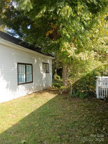 a view of a house with a yard and sitting area