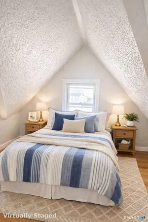 a bedroom with a large bed and a couch