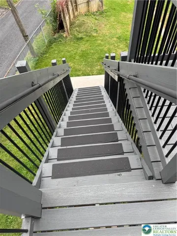 a view of stairs and yard from balcony