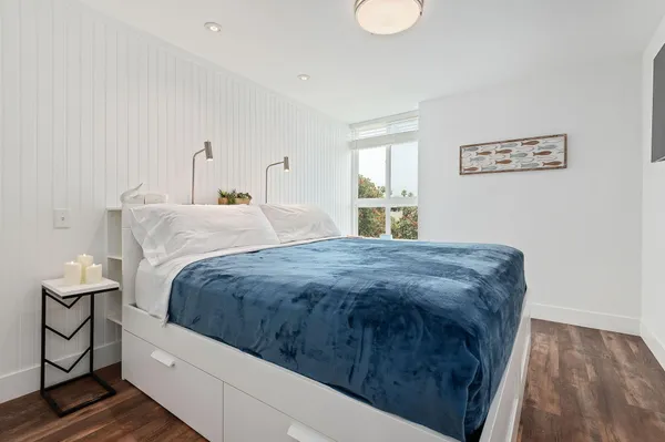 a spacious bedroom with a bed and window