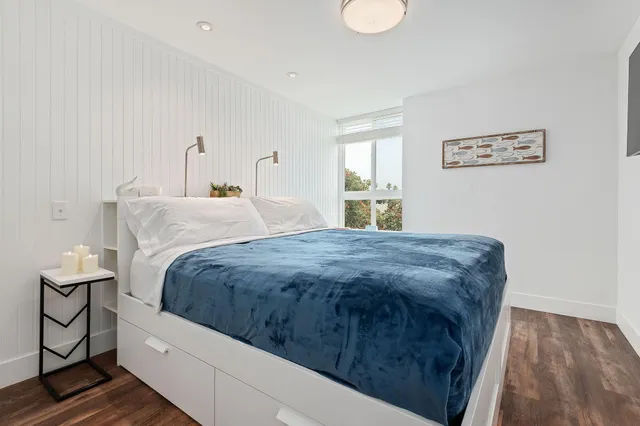 a spacious bedroom with a bed and window