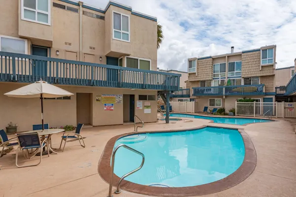 a view of a house with swimming pool and sitting area