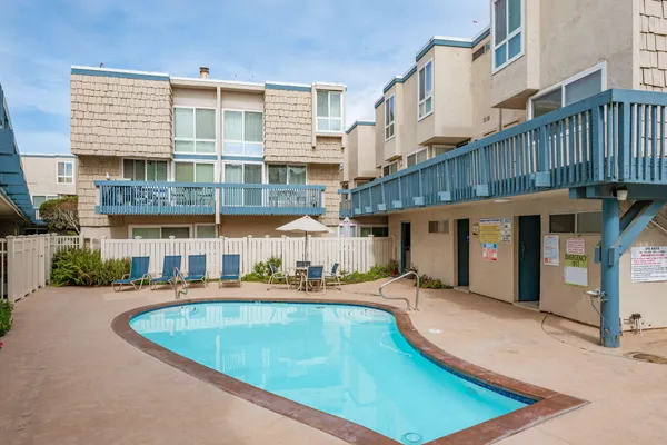 a view of a large building with a swimming pool