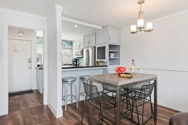 a view of a dining room with furniture and wooden floor