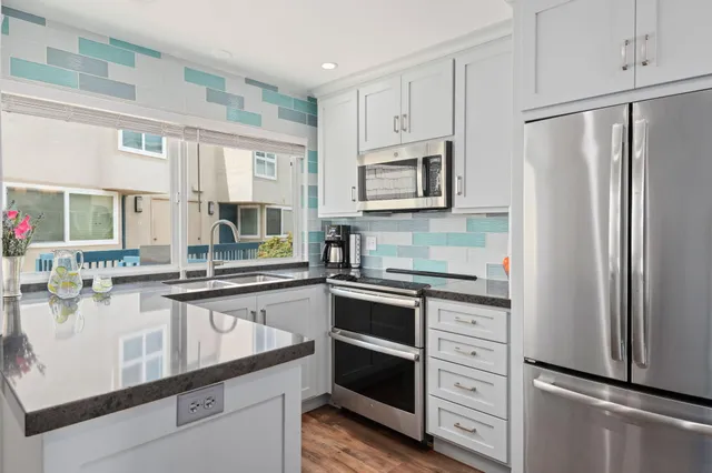 a kitchen with stainless steel appliances a refrigerator stove and sink