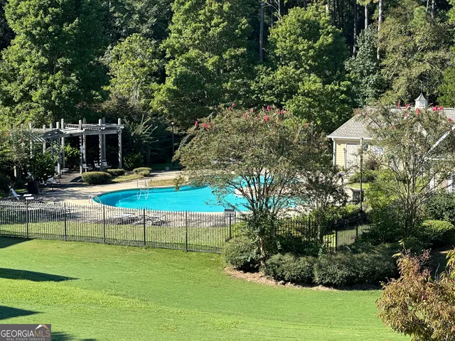 an outdoor space with swimming pool and furniture