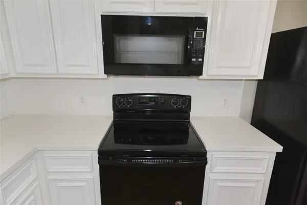 a close view of a stove and microwave