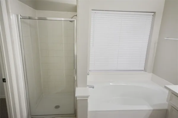 a bathroom with a shower and a glass door
