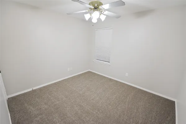 a view of an empty room with a fan