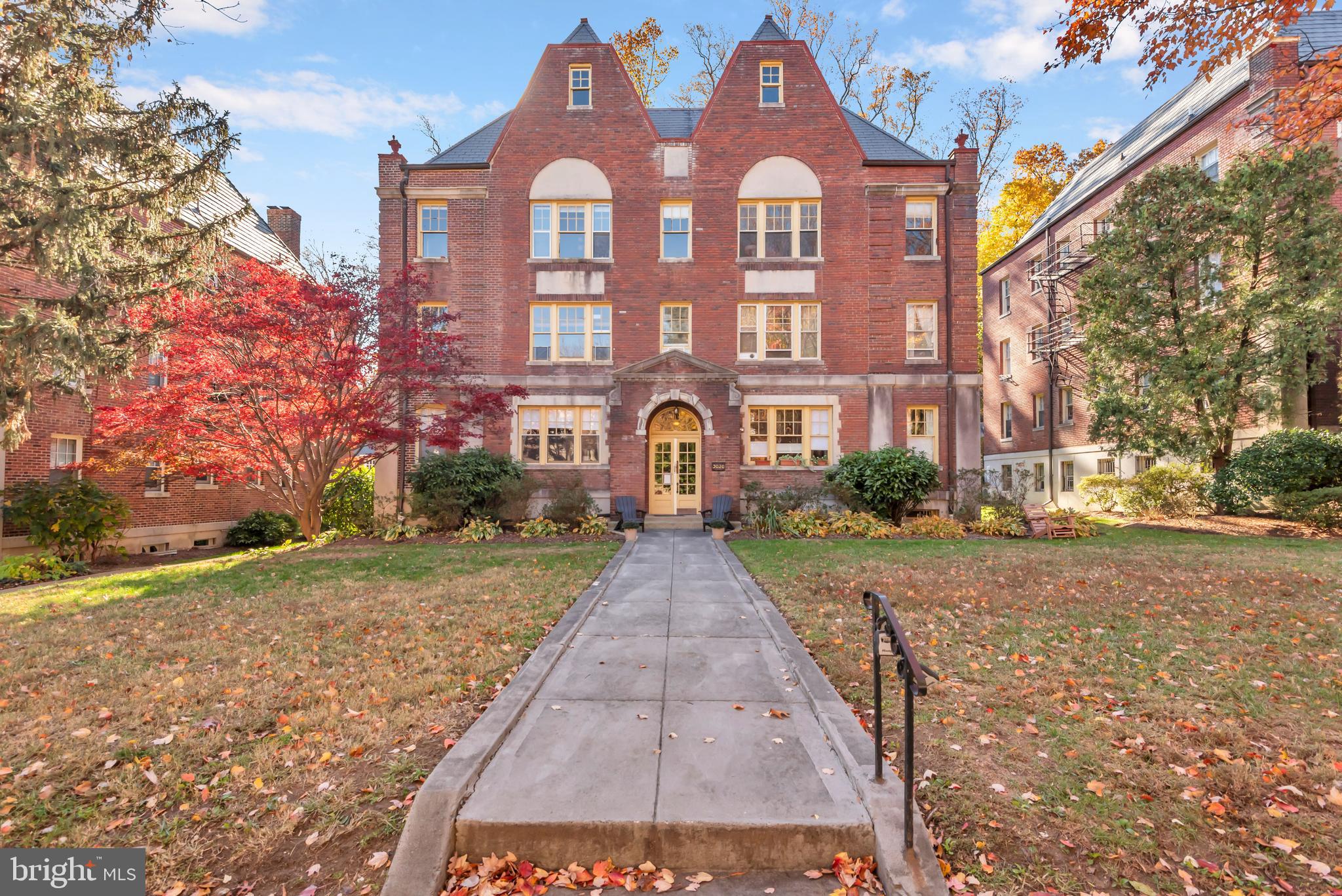 3020 Porter Street Northwest, Unit 103 Washington, DC 20008 - Photo 1 of 30 a view of a brick building next to a yard