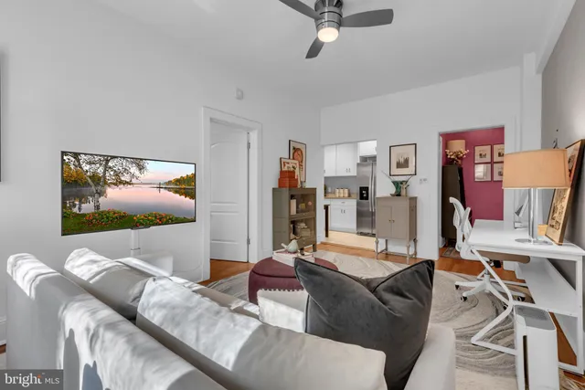 a bedroom with furniture and a flat screen tv