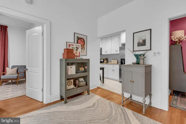 a kitchen with cabinets and a refrigerator